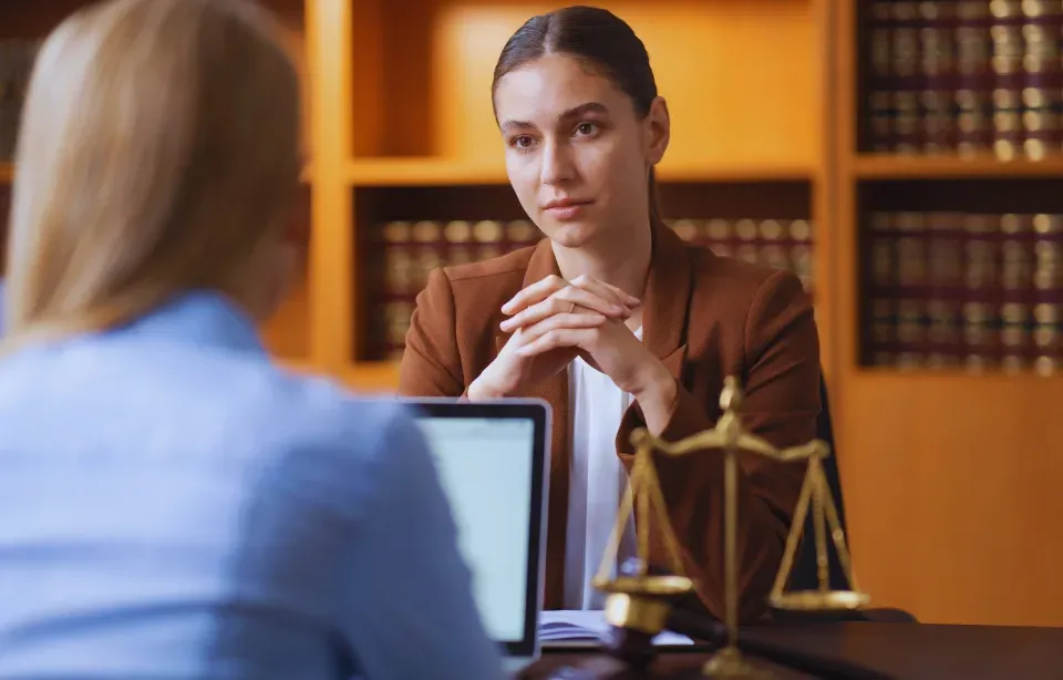 Solicitor meeting a client in a law firm library